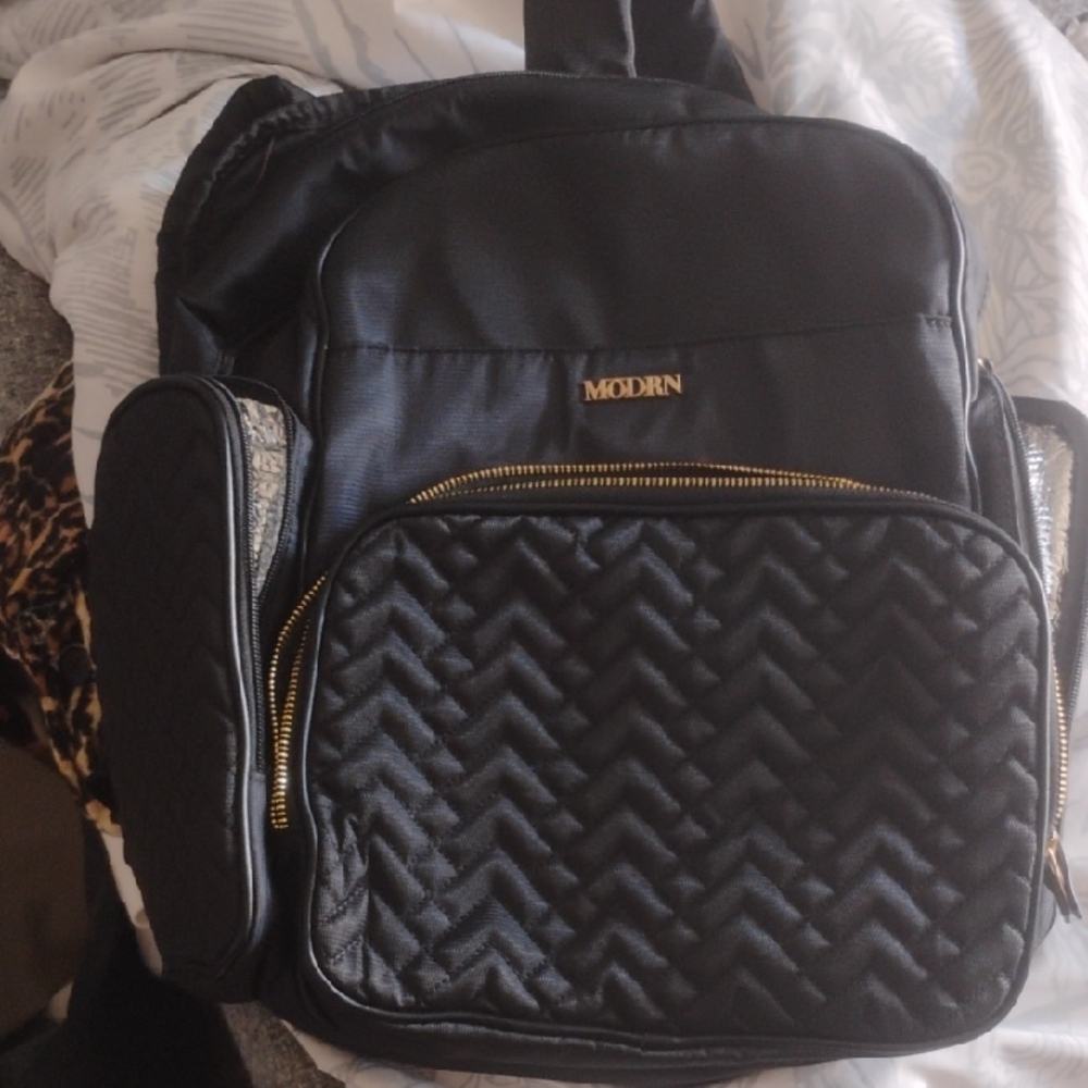 Sleek Black Quilted Backpack with Gold Hardware
